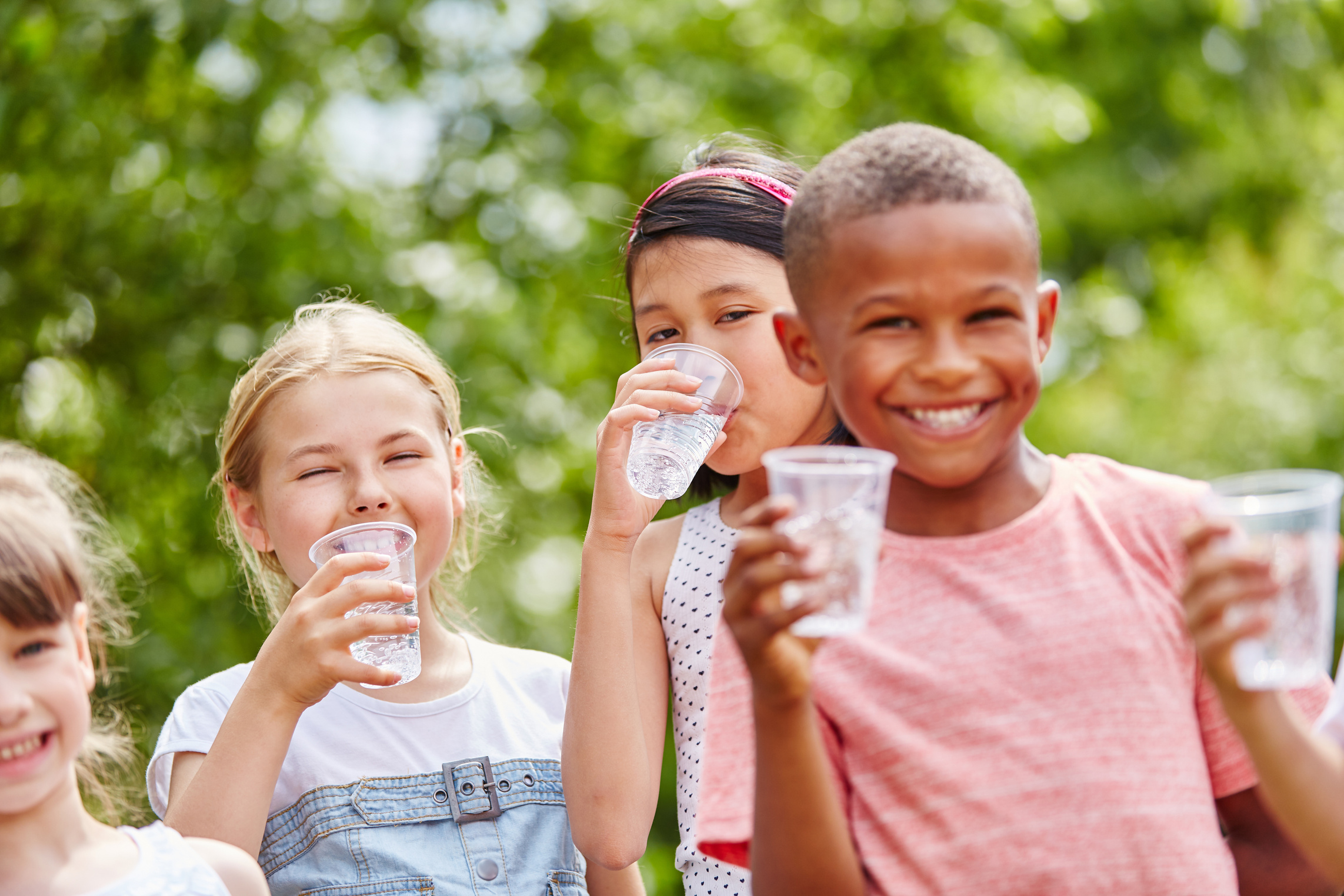Children with Plastic Cups Drinking Water